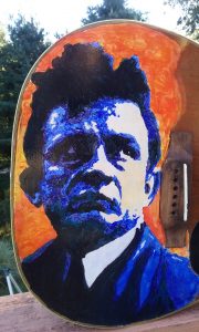 This acoustic guitar has been painted with Johnny Cash.